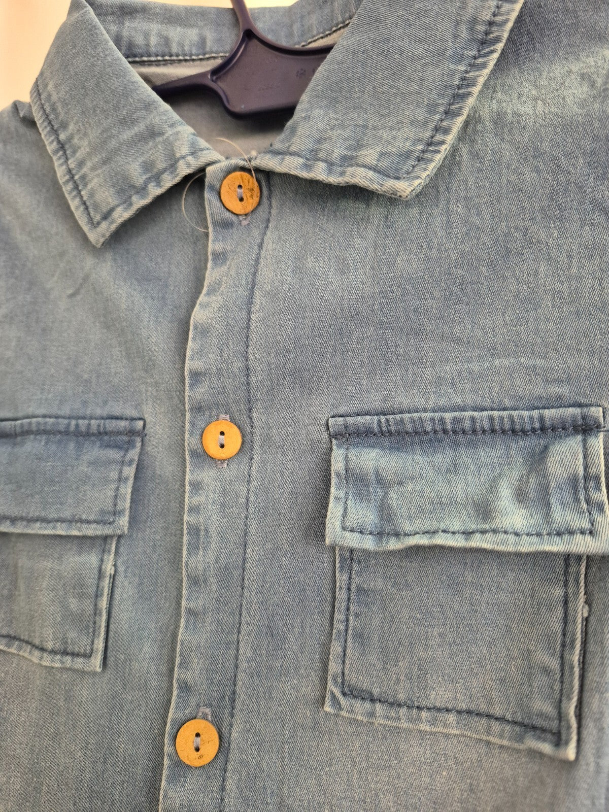 Lingxibeier blue denim jumpsuit with giraffe pattern, long sleeves, and front pockets.