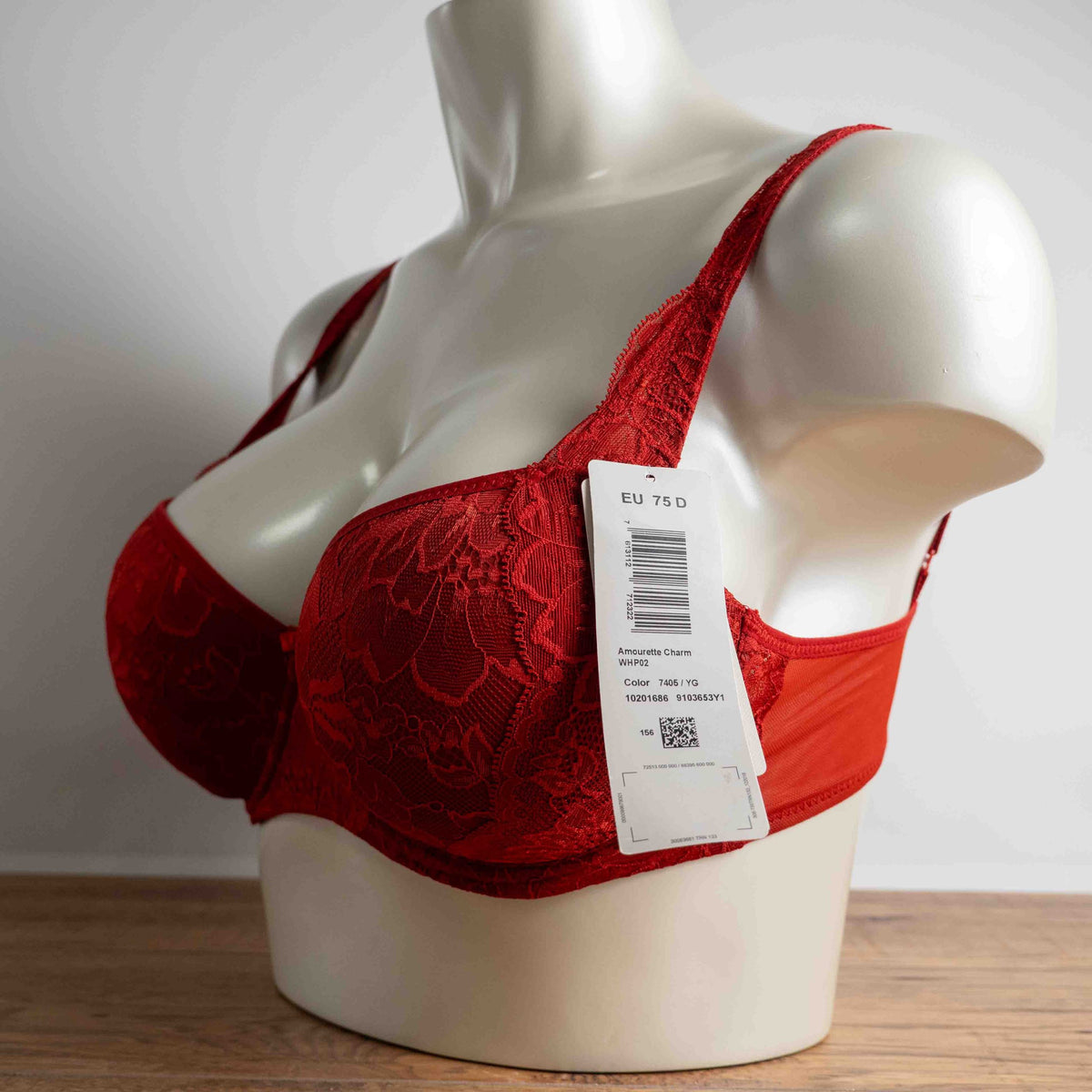 Triumph red lace bra with padded cups and adjustable straps, new with tags.