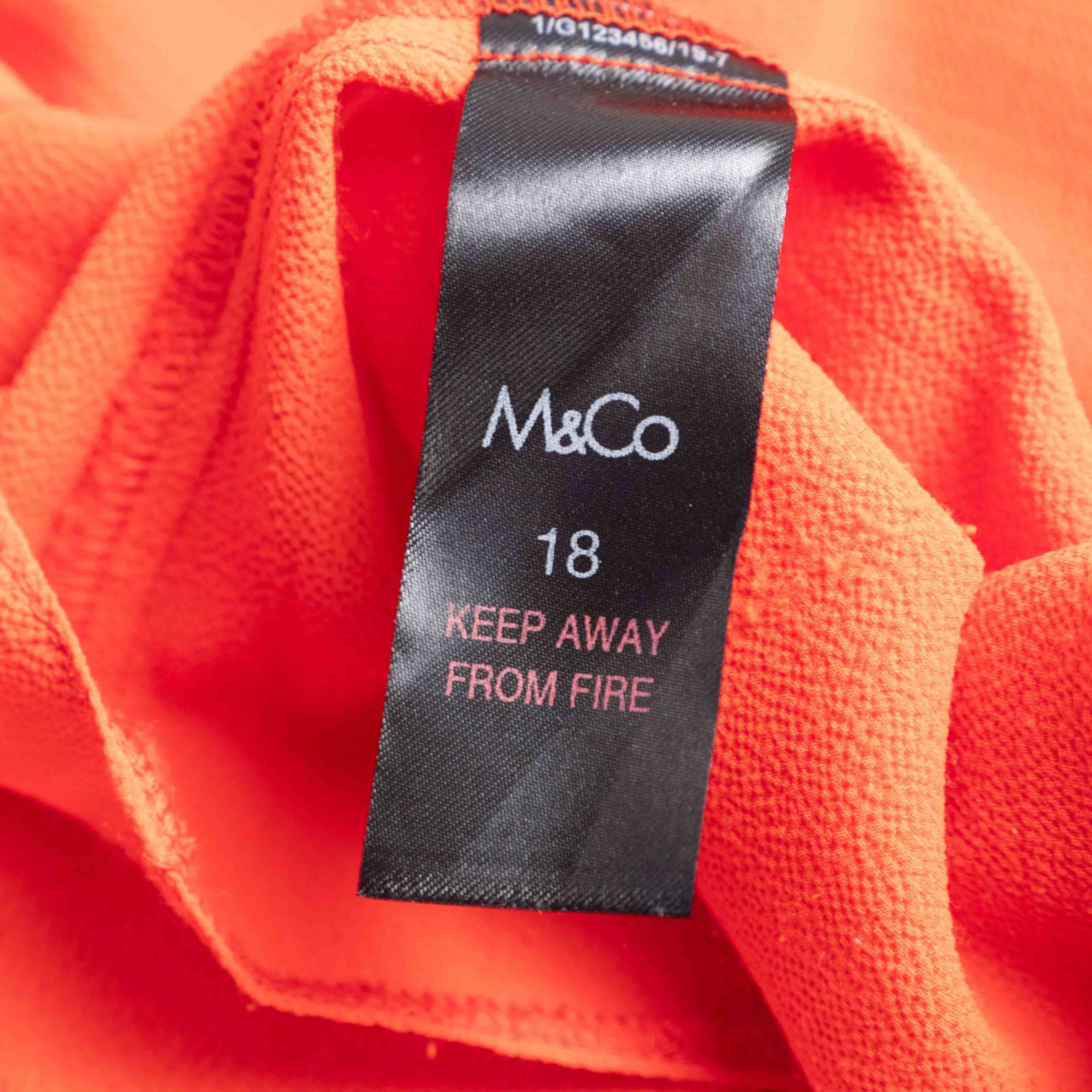 M&Co red layered blouse with short sleeves, made of polyester and elastane.