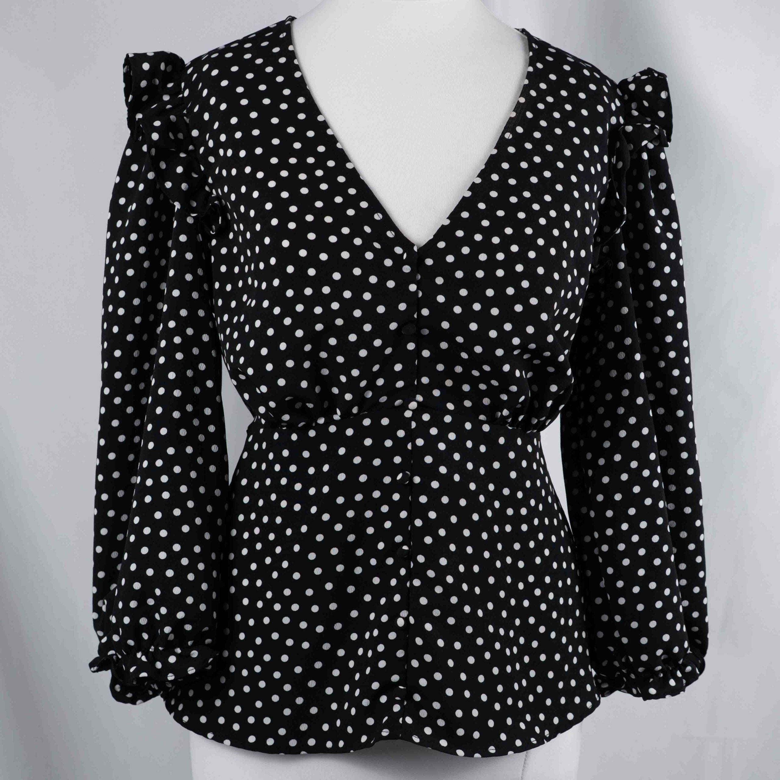 New Look black and white polka dot tunic blouse with V-neck and ruffled sleeves.