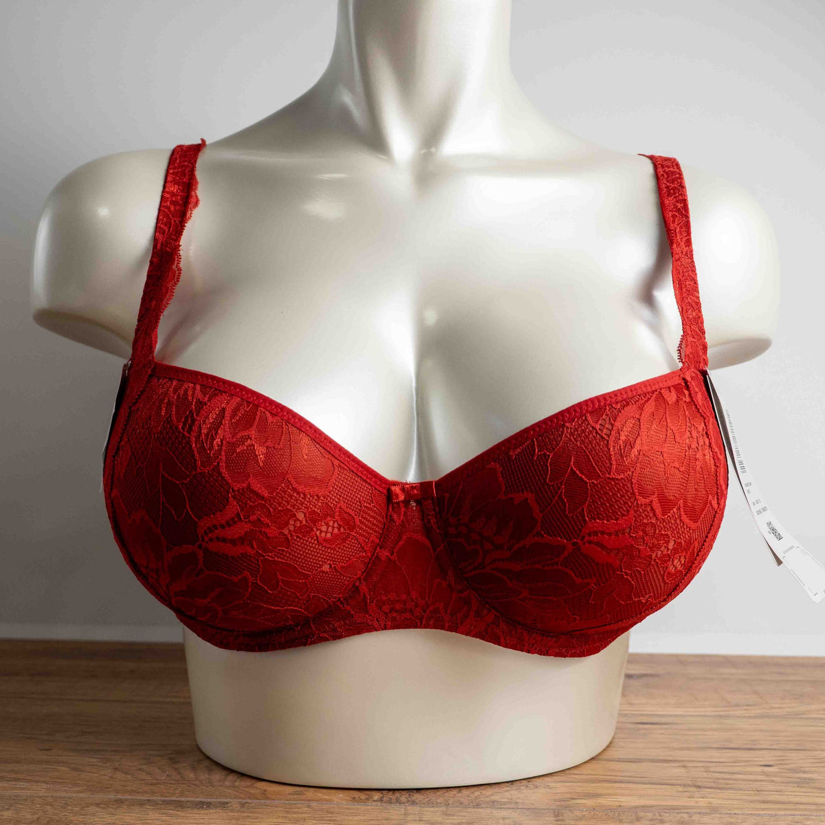 Triumph red lace bra with padded cups and adjustable straps, new with tags.