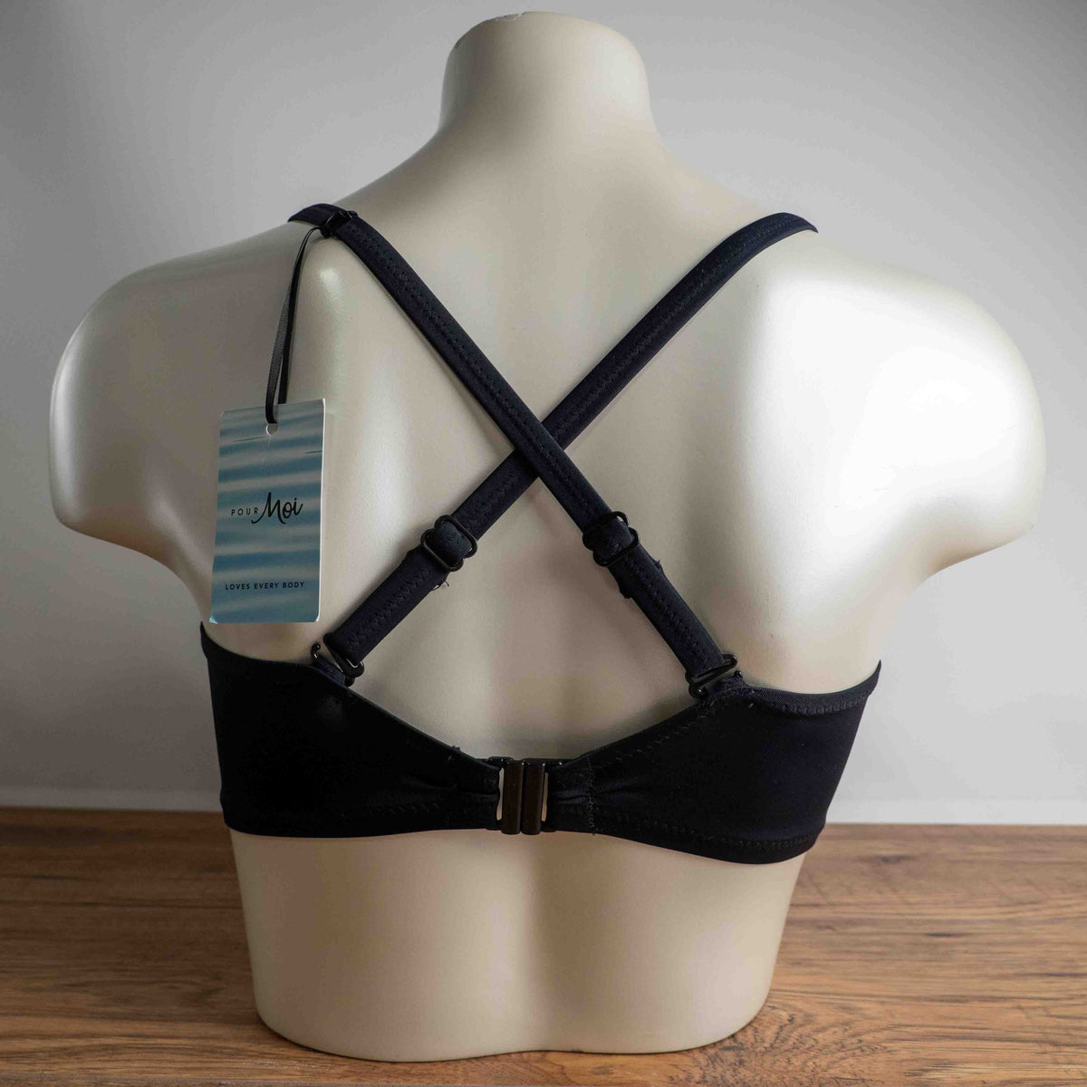 Pour Moi black bikini top with eyelet ruffle detail and adjustable straps.