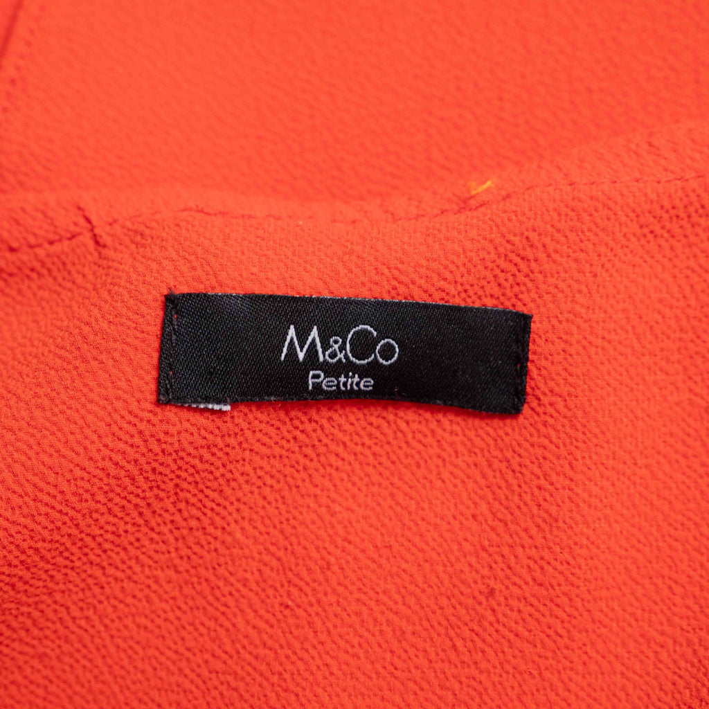 M&Co red layered blouse with short sleeves, made of polyester and elastane.