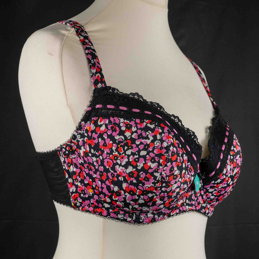 Debenhams pink and red floral bra with black lace trim and adjustable straps.