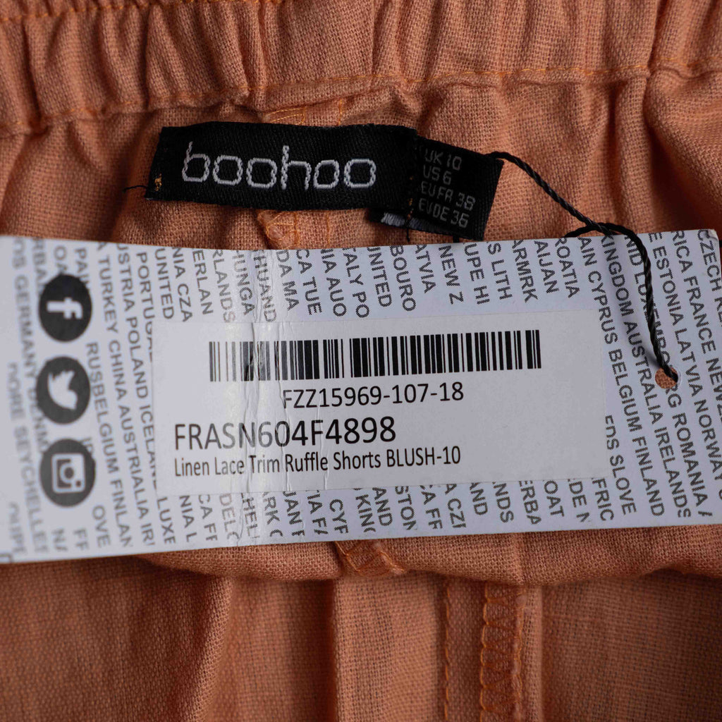 Boohoo orange linen ruffle shorts with lace trim and elasticated waistband.