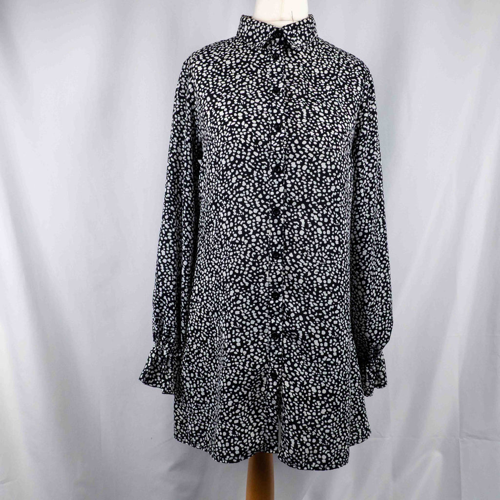 Missguided black and white spot print shirt with button-down front and flared cuffs.