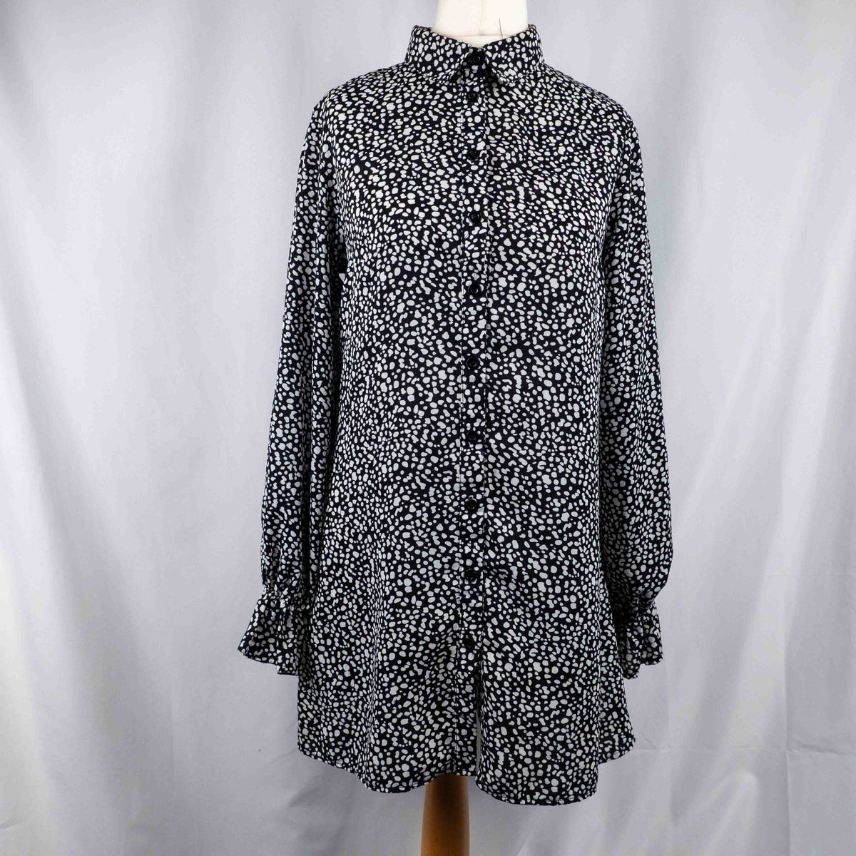 Missguided black and white spot print shirt with button-down front and flared cuffs.