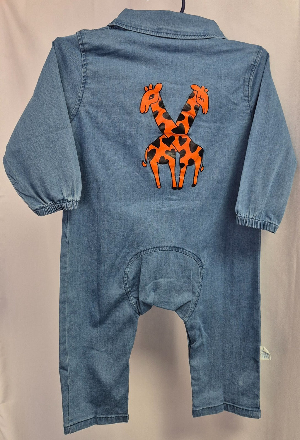 Lingxibeier blue denim jumpsuit with giraffe pattern, long sleeves, and front pockets.