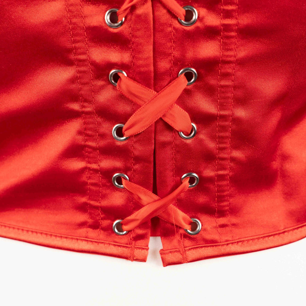 Red corset top with sheer floral lace bodice and satin sides, adjustable lace-up back.