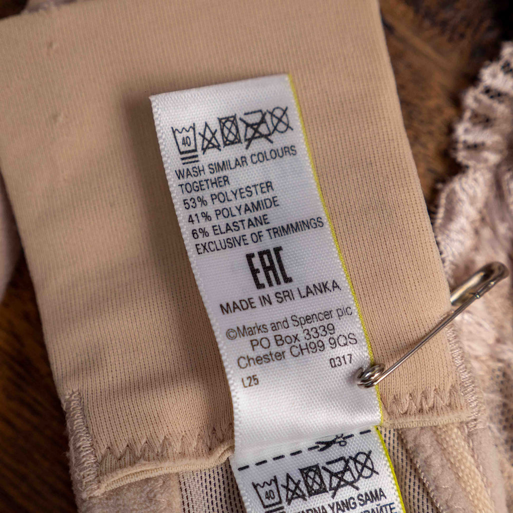 Marks and Spencer beige padded underwired bra with floral lace detail and decorative bow.