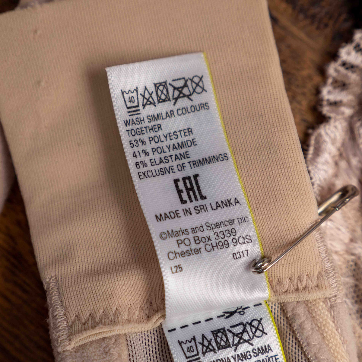Marks and Spencer beige padded underwired bra with floral lace detail and decorative bow.