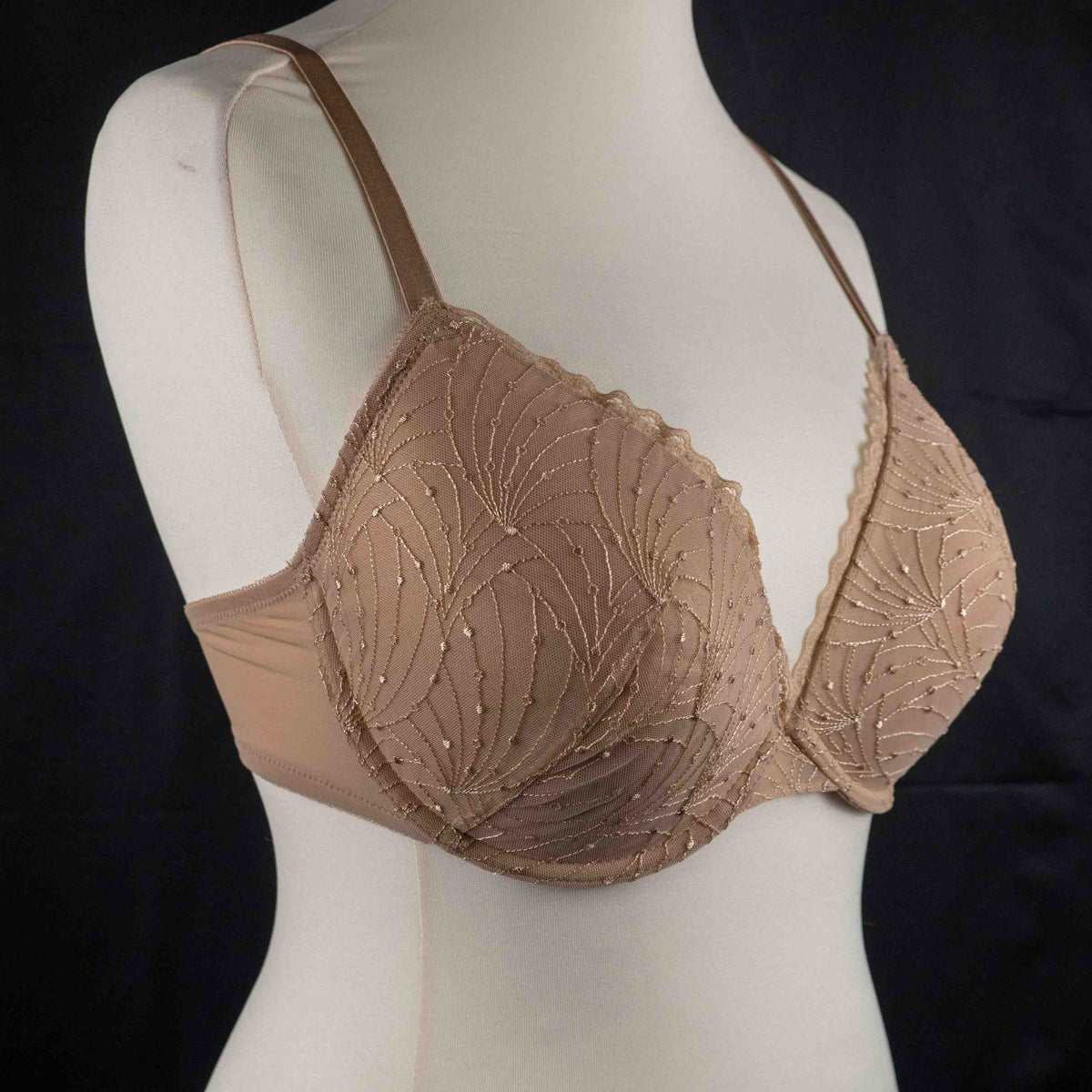 Wacoal beige and black underwired bras with floral lace design and adjustable straps.