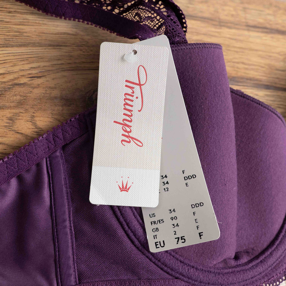 Triumph purple bra with floral lace pattern, adjustable straps, and hook-and-eye closure.