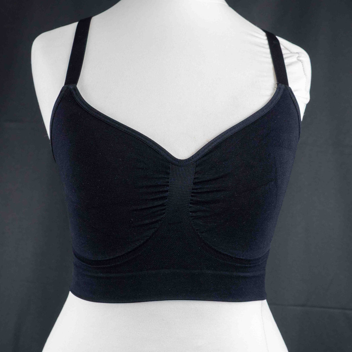 Dyversa black seamless bra with ruched center detail and adjustable straps.