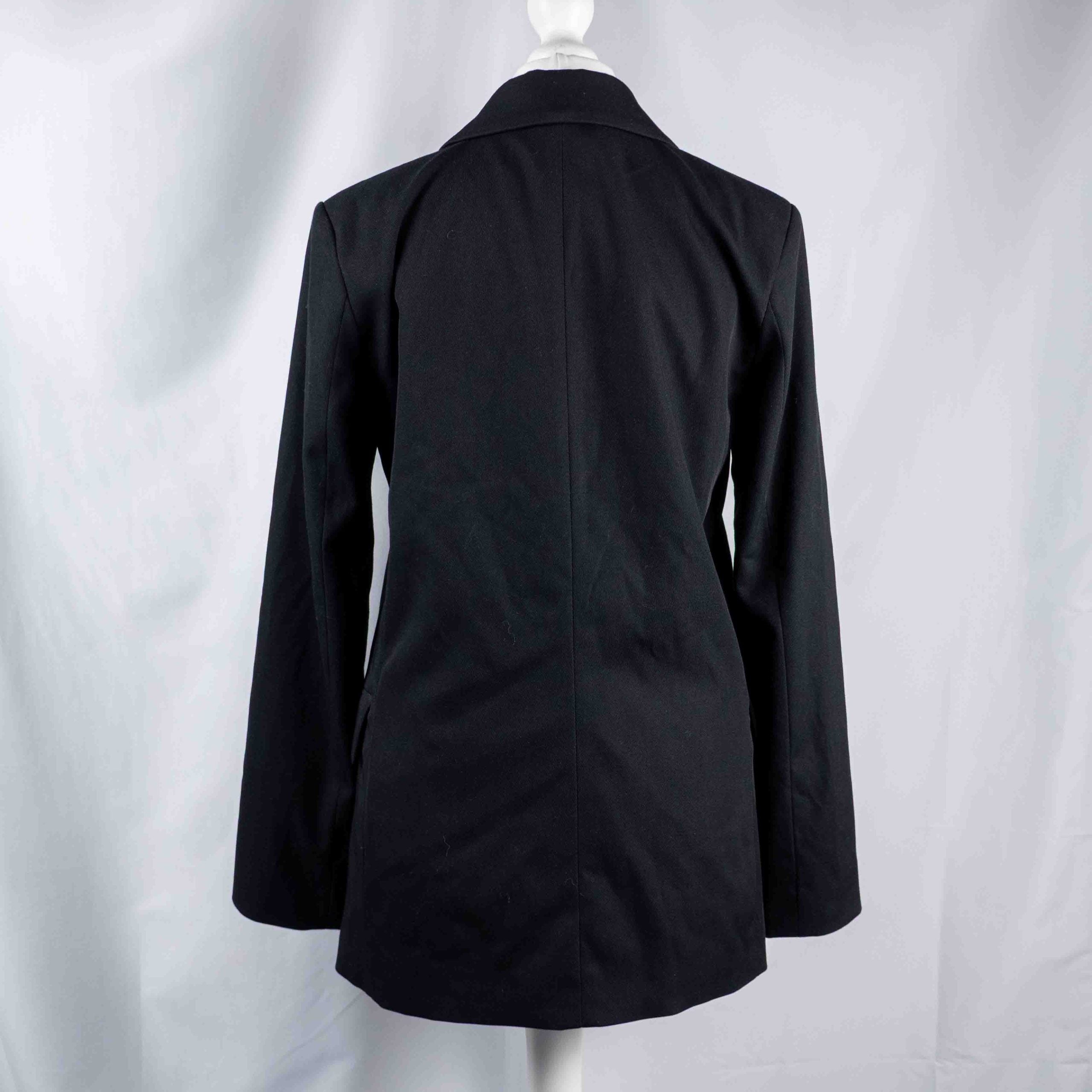 H&M black double-breasted blazer with structured lapel and six front buttons.