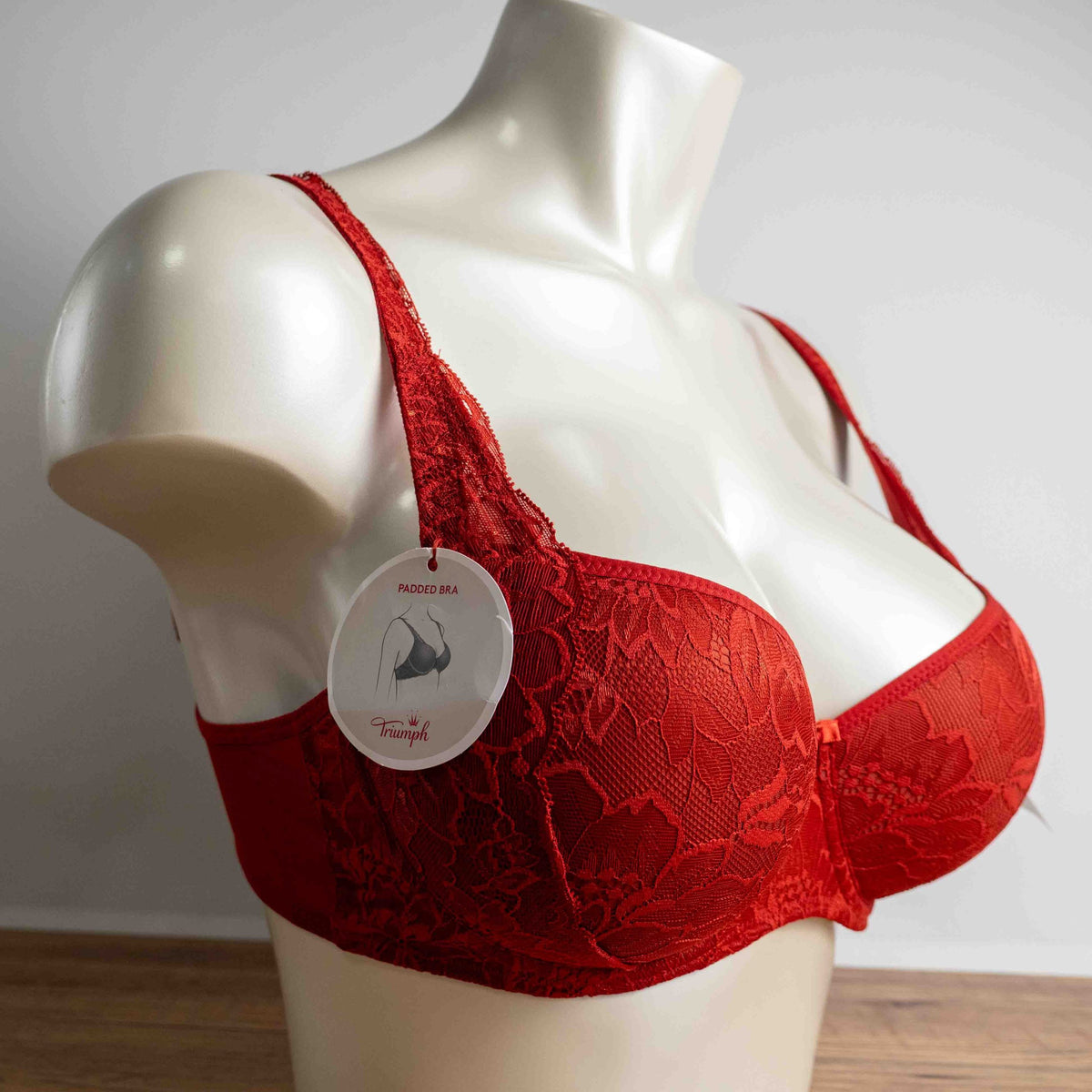Triumph red lace bra with padded cups and adjustable straps, new with tags.