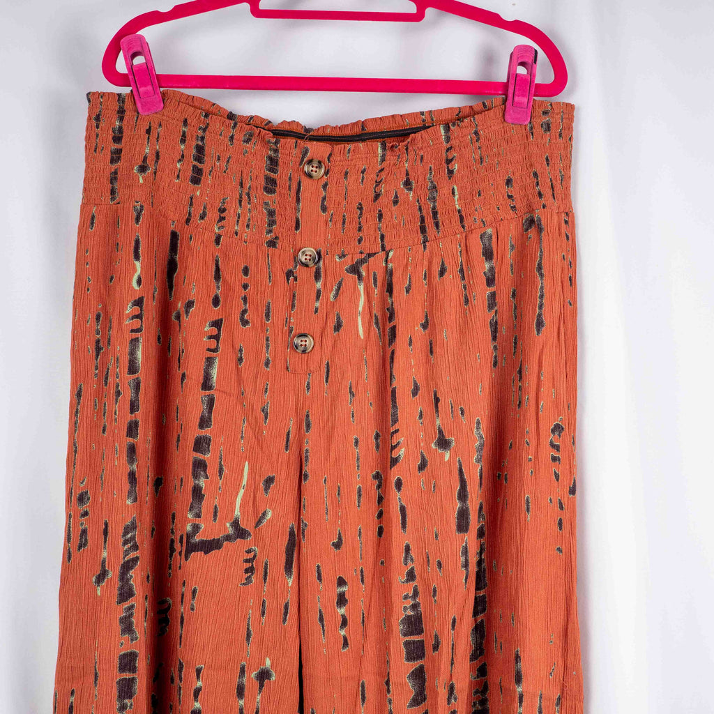 Bodyflirt orange wide-leg trousers with abstract black print and smocked waistband.