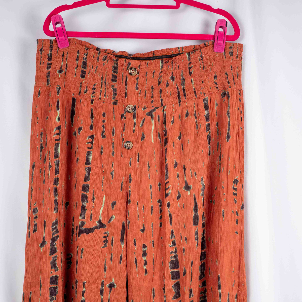 Bodyflirt orange wide-leg trousers with abstract black print and smocked waistband.