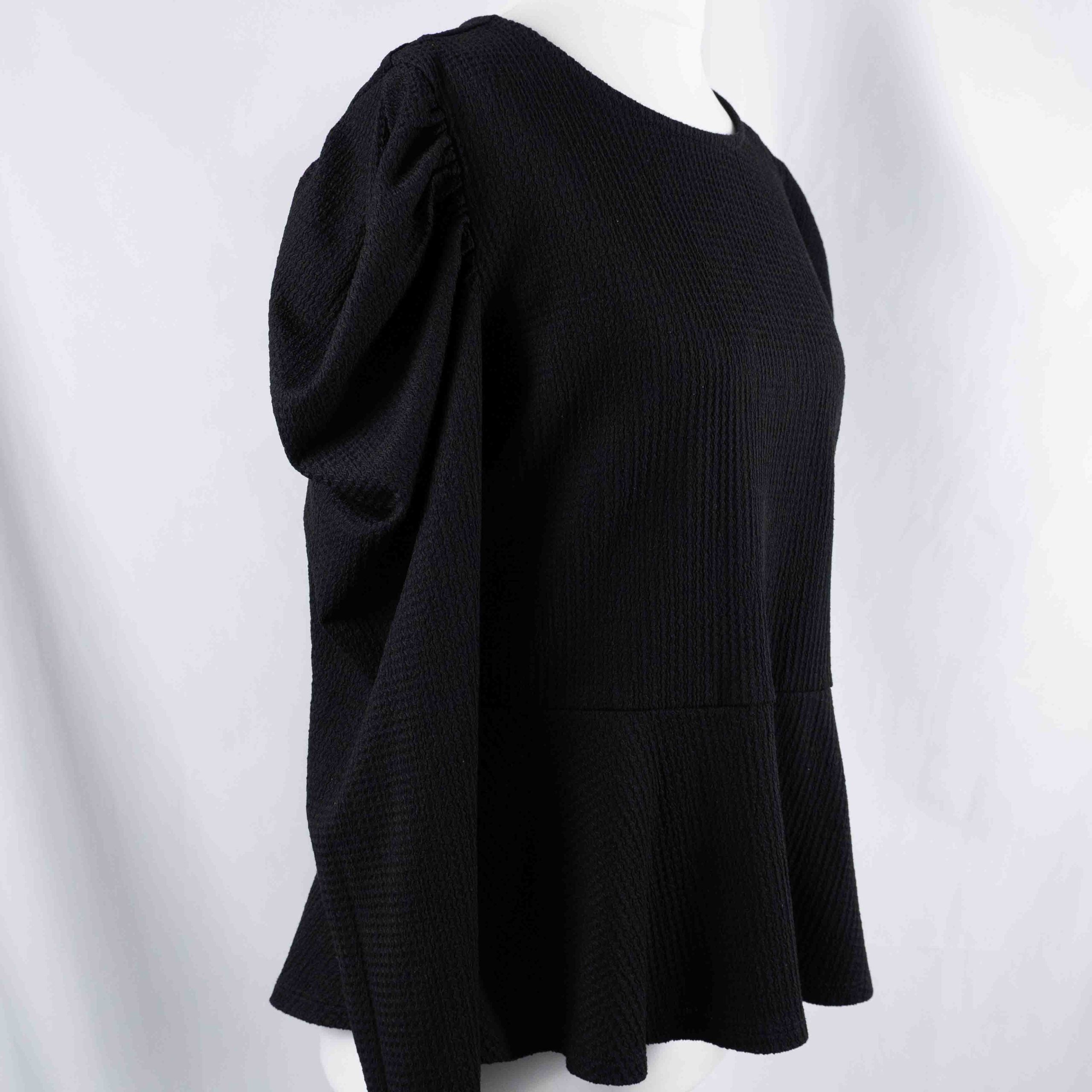 Dorothy Perkins black blouse with peplum hem and textured puff sleeves.