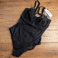 Empreinte black shapewear bodysuit with lace detailing, underwired cups, adjustable straps.