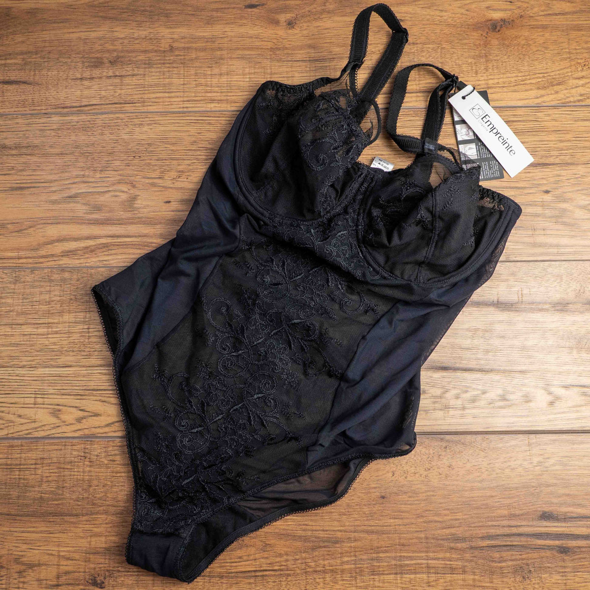 Empreinte black shapewear bodysuit with lace detailing, underwired cups, adjustable straps.