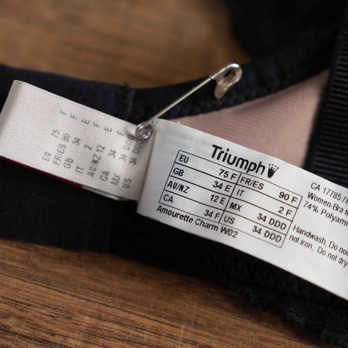 Triumph black lace bra with elegant overlay, underwired, adjustable straps, brand new with tags.