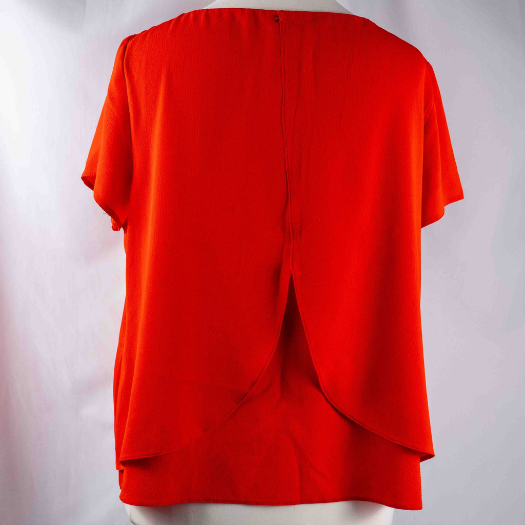 M&Co red layered blouse with short sleeves, made of polyester and elastane.