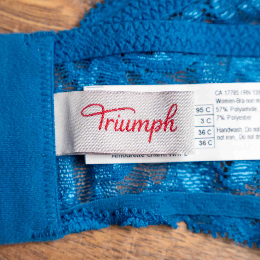 Triumph blue lace underwired bra with floral patterns and small bow detail.