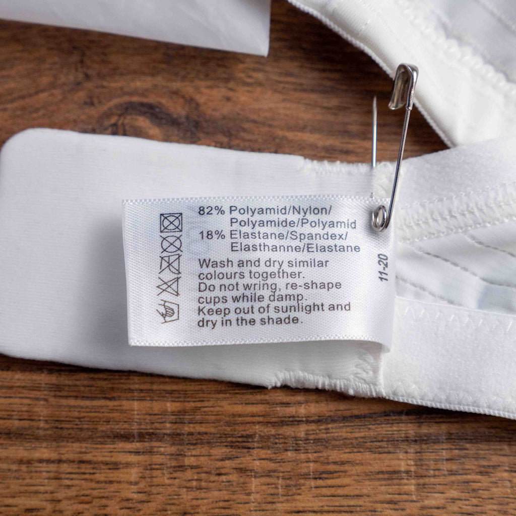 Nicola Jane white mastectomy bra with adjustable straps and back hook closure.