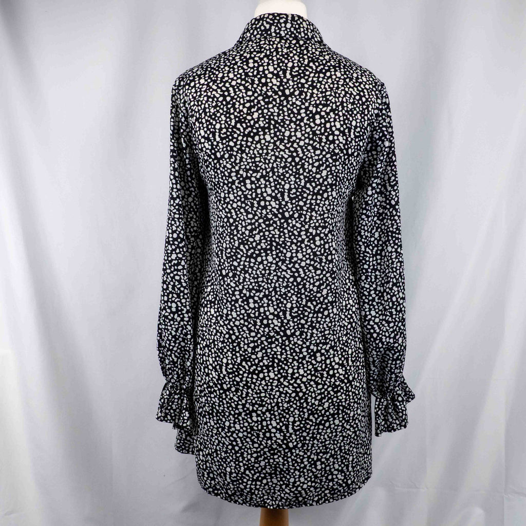 Missguided black and white spot print shirt with button-down front and flared cuffs.