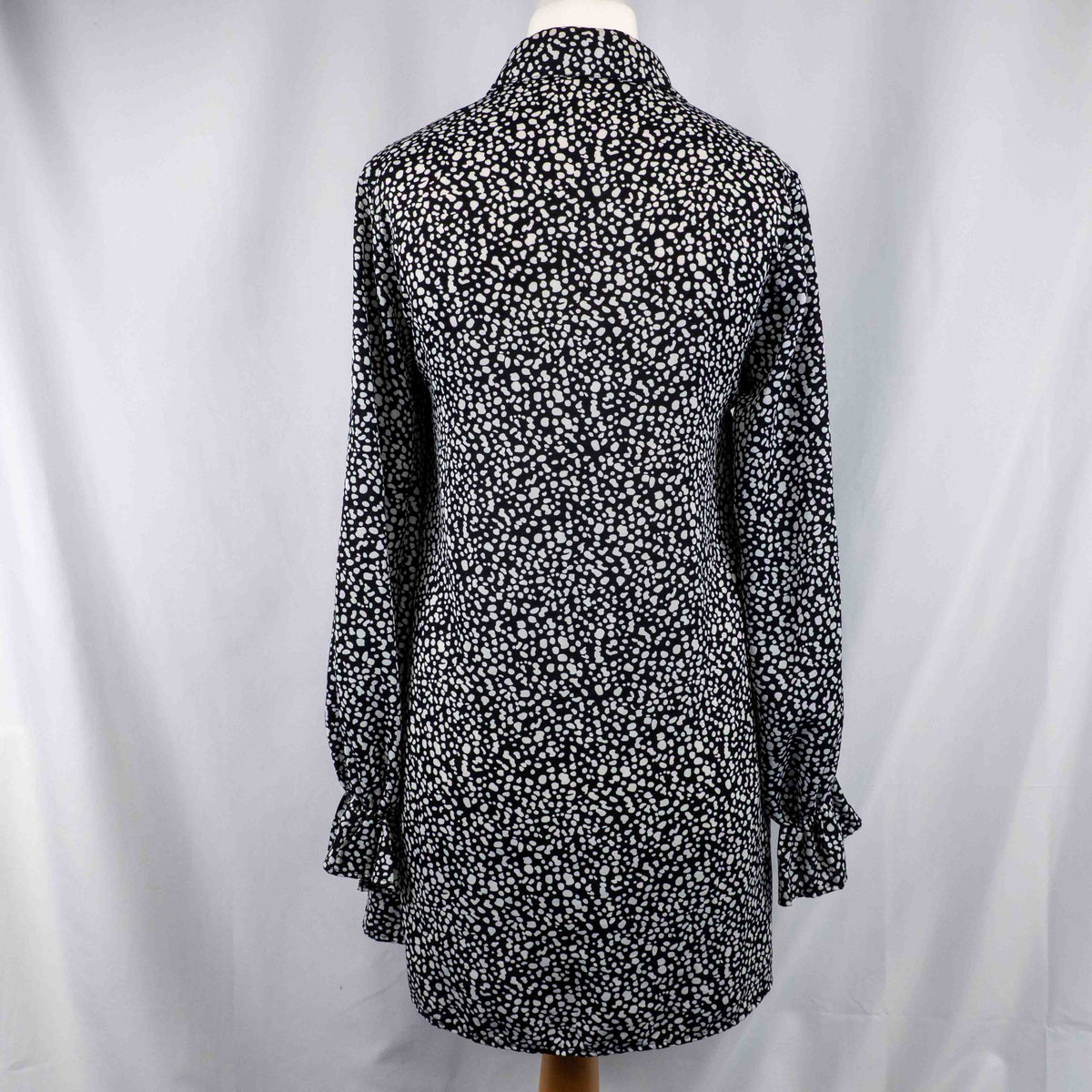 Missguided black and white spot print shirt with button-down front and flared cuffs.