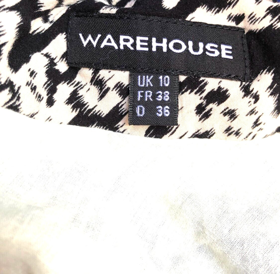 Warehouse black and white patterned shift dress, sleeveless, round neck, back zip.