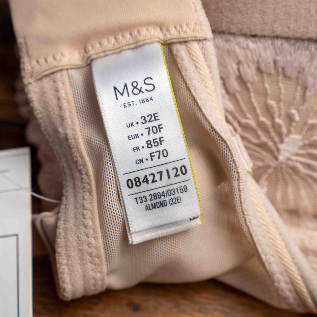 Marks and Spencer beige padded underwired bra with floral lace detail and decorative bow.
