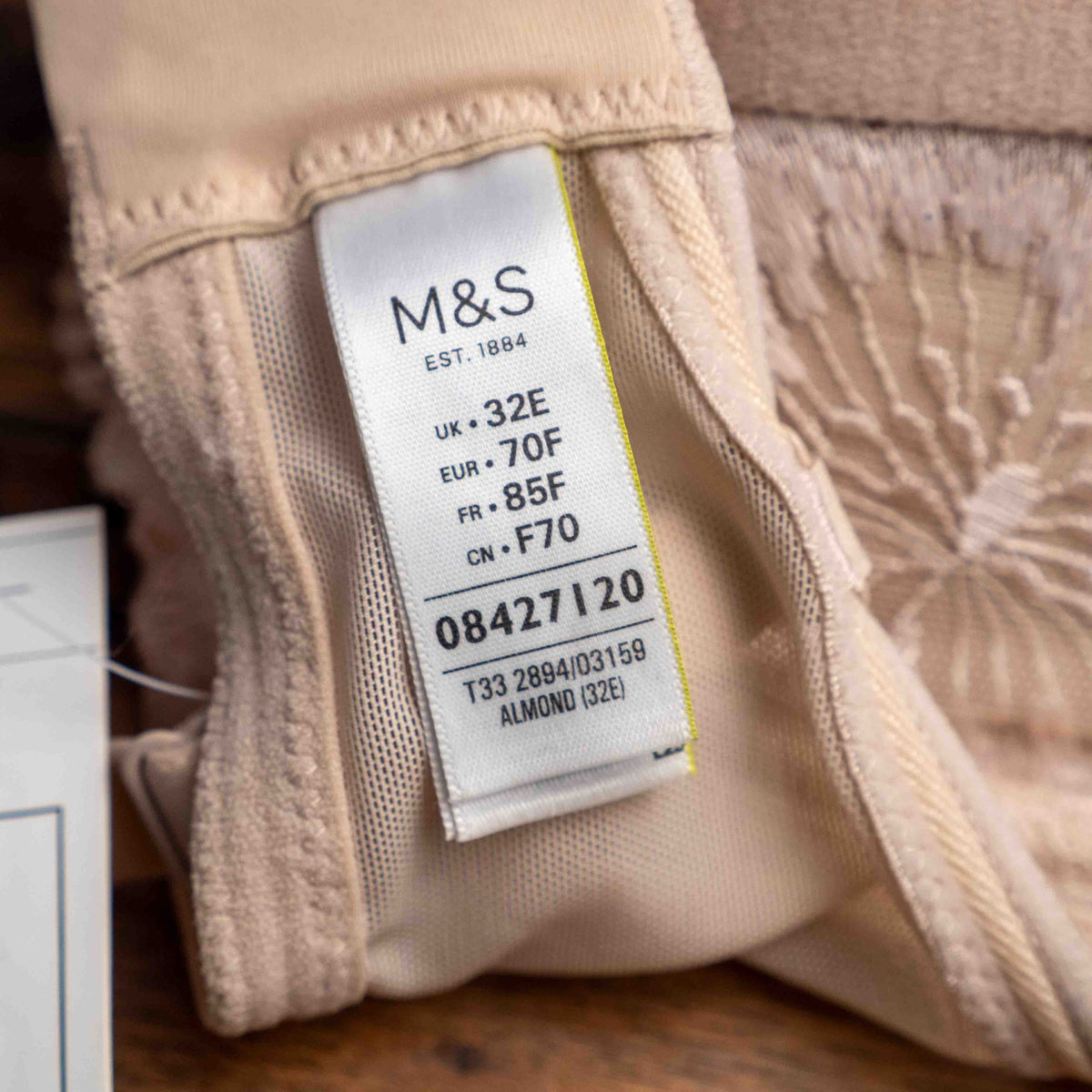 Marks and Spencer beige padded underwired bra with floral lace detail and decorative bow.