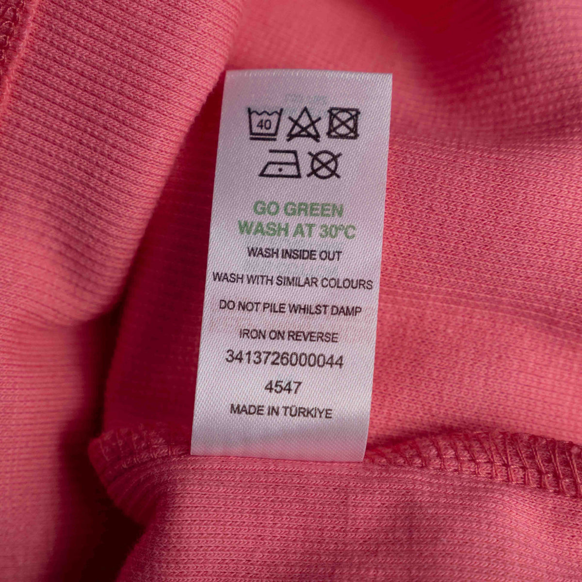 Papaya pink midi dress with ruffle sleeves and soft ribbed knit fabric.