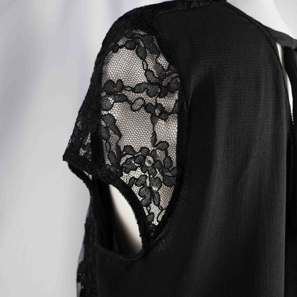 Black lace sleeve top with V neckline and tie-back detail, feminine style.