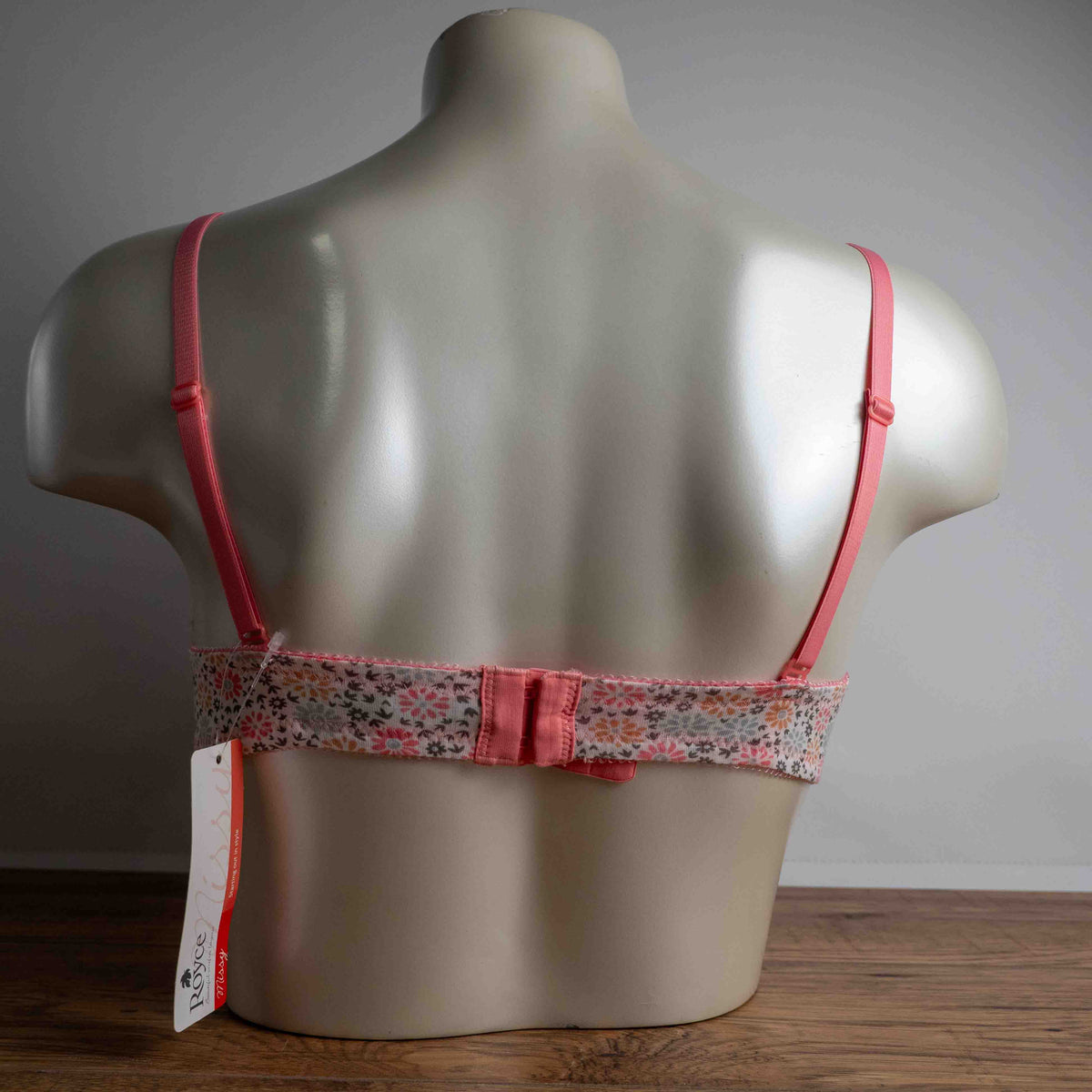 Royce white floral wire-free bra with pink straps and small pink bow detail.