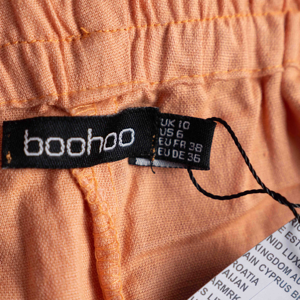 Boohoo orange linen ruffle shorts with lace trim and elasticated waistband.
