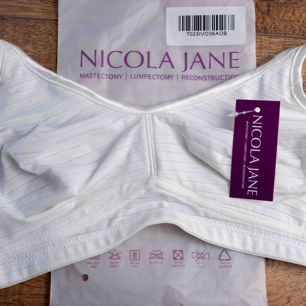 Nicola Jane white mastectomy bra with adjustable straps and back hook closure.
