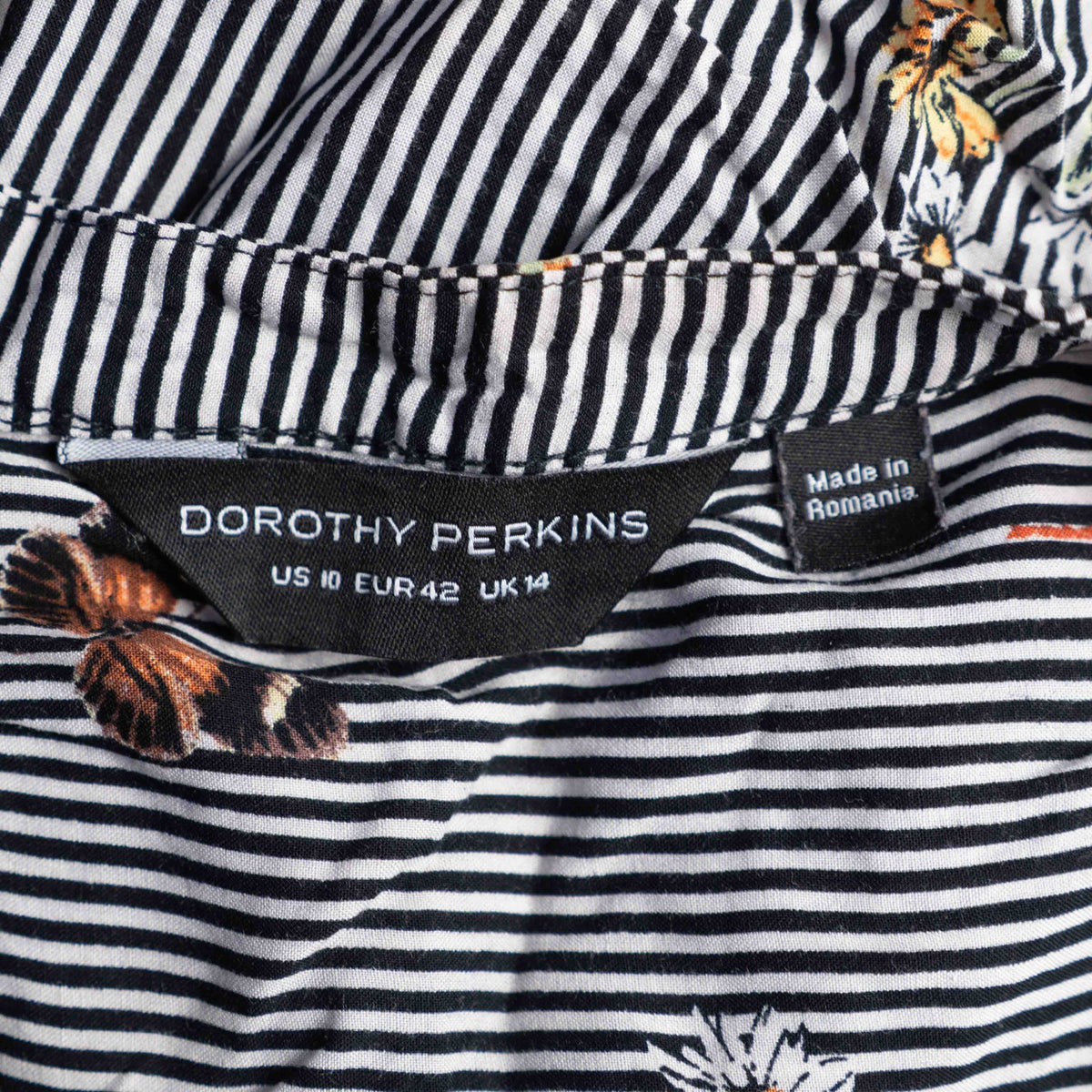 Dorothy Perkins black and white striped blouse with colourful butterfly print and tie cuffs.
