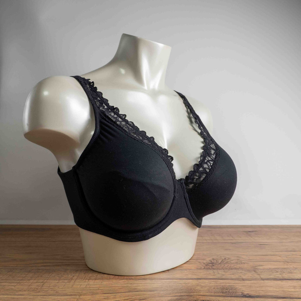 Next black plunge bra with lace trim, adjustable straps, and branded detailing.