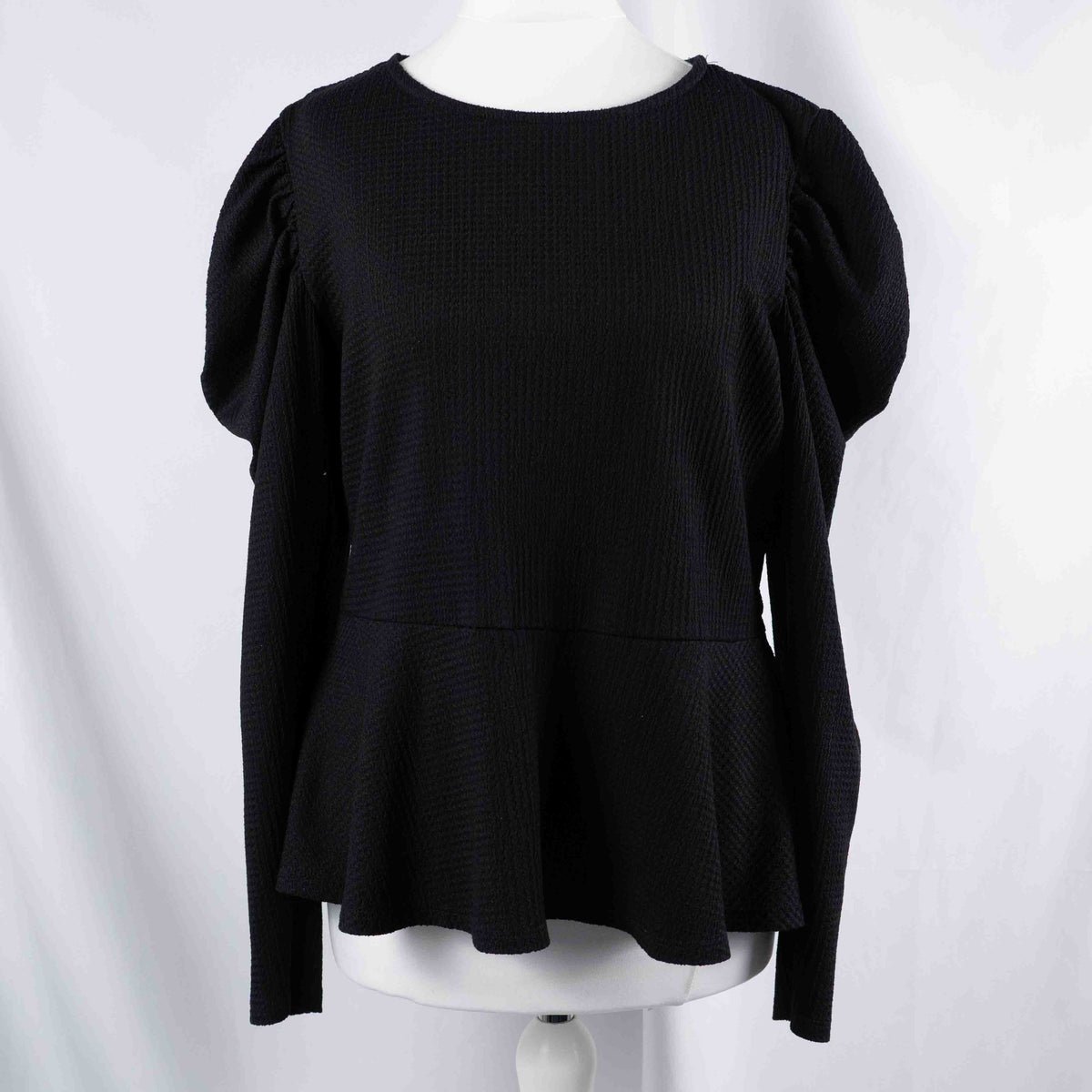 Dorothy Perkins black blouse with peplum hem and textured puff sleeves.