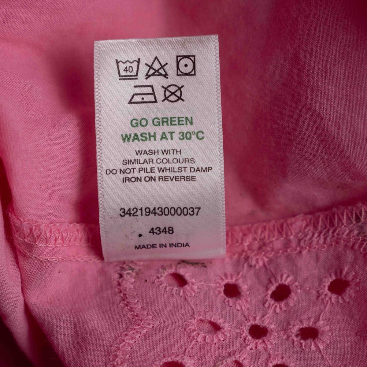 Papaya pink casual dress with embroidered floral patterns and flutter sleeves.