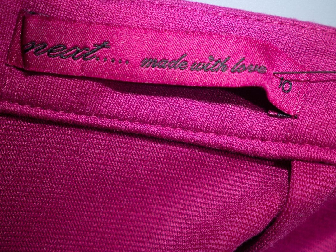 Next pink mini skirt with back zip closure and pleated front, new with tag.