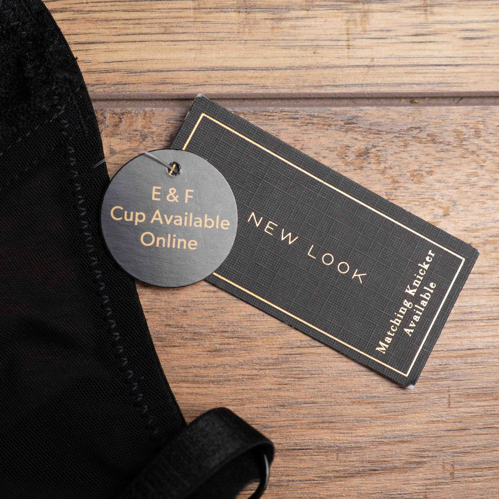 New Look black balconette bra with pink floral embroidery and decorative strappy back.