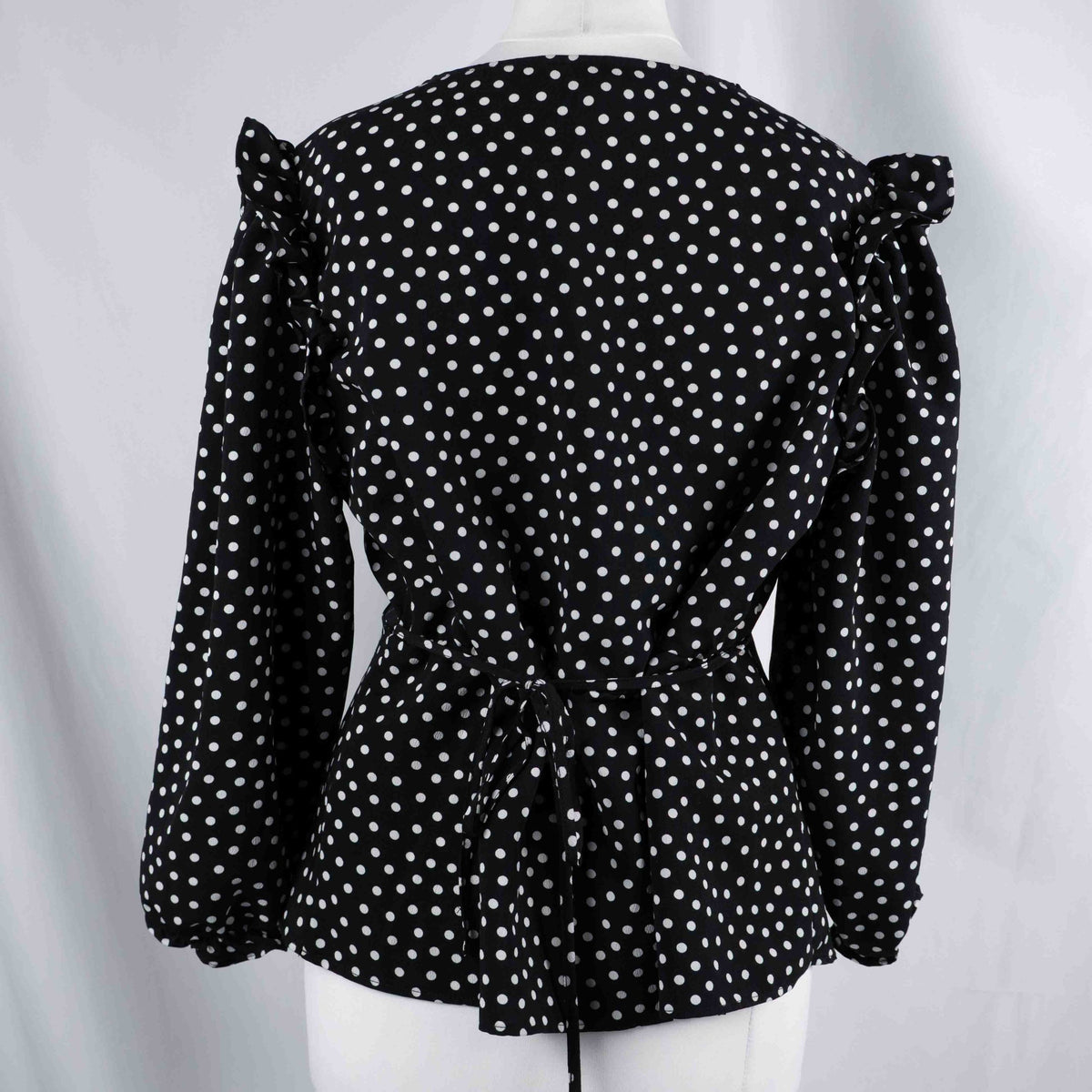 New Look black and white polka dot tunic blouse with V-neck and ruffled sleeves.