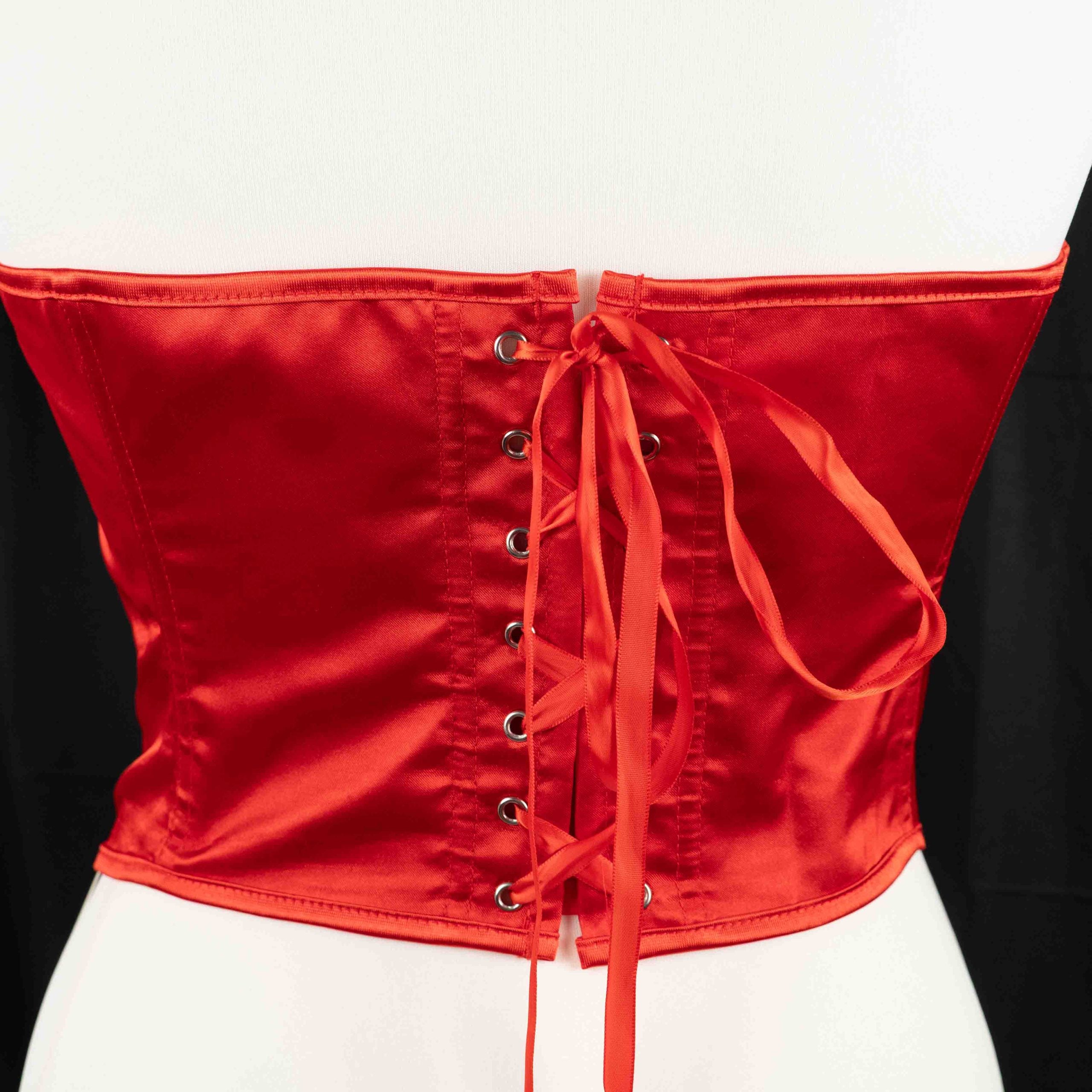 Red corset top with sheer floral lace bodice and satin sides, adjustable lace-up back.