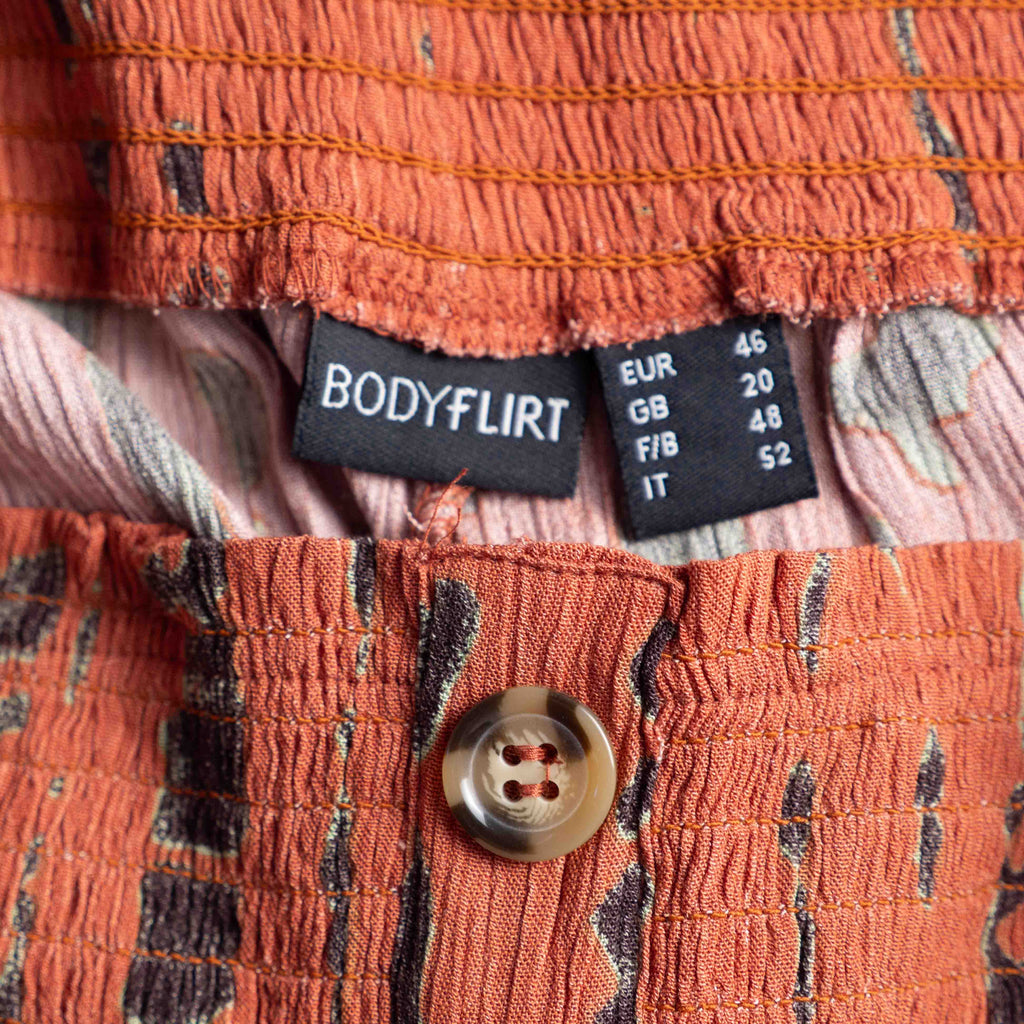 Bodyflirt orange wide-leg trousers with abstract black print and smocked waistband.