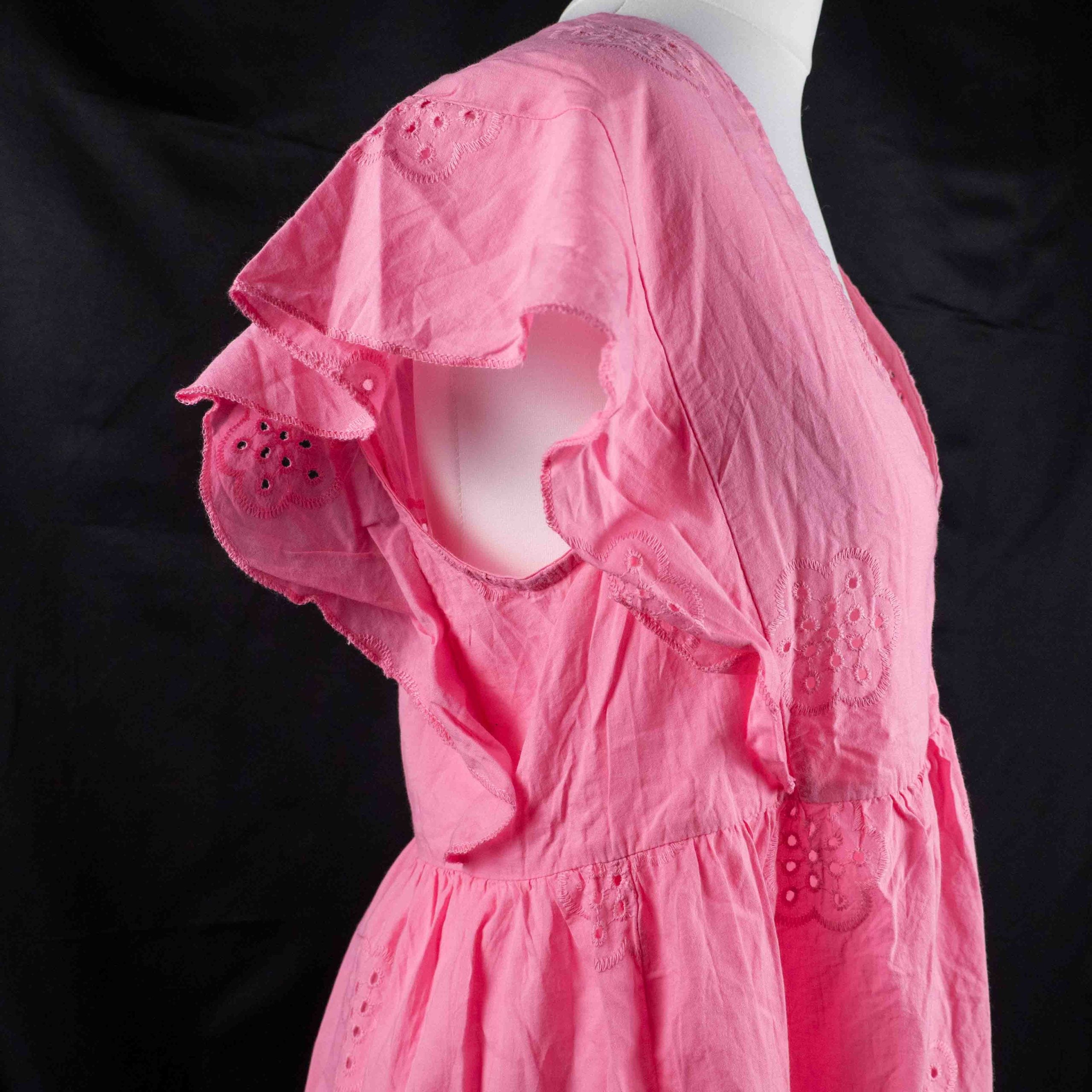 Papaya pink casual dress with embroidered floral patterns and flutter sleeves.