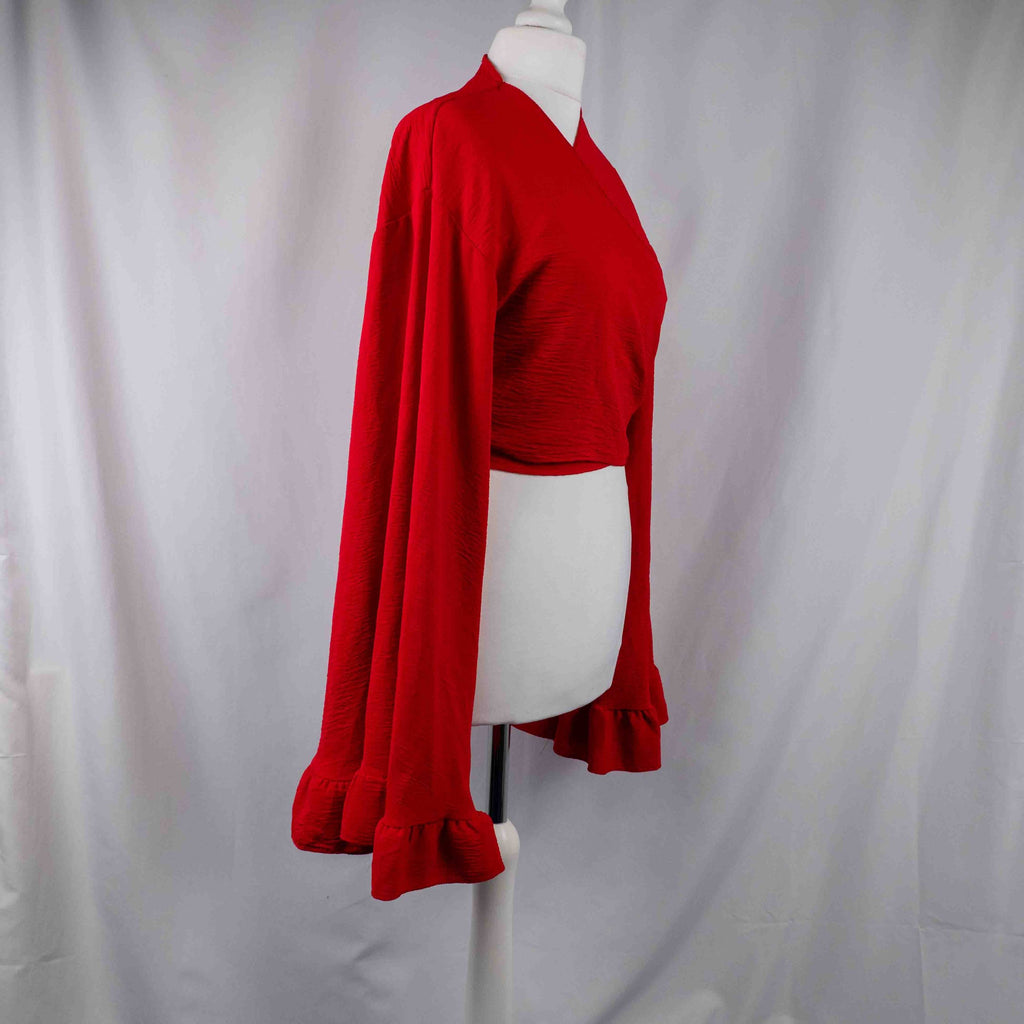 Boohoo red wrap crop top with floral print, ruffle cuffs, and tie-back design.